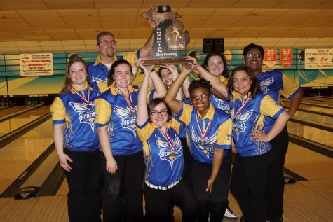 The girls bowling team celebrates its fifth consecutive state title, Friday, March 2, after winning the MHSAA Division 2 tournament at the Super Bowl in Canton.