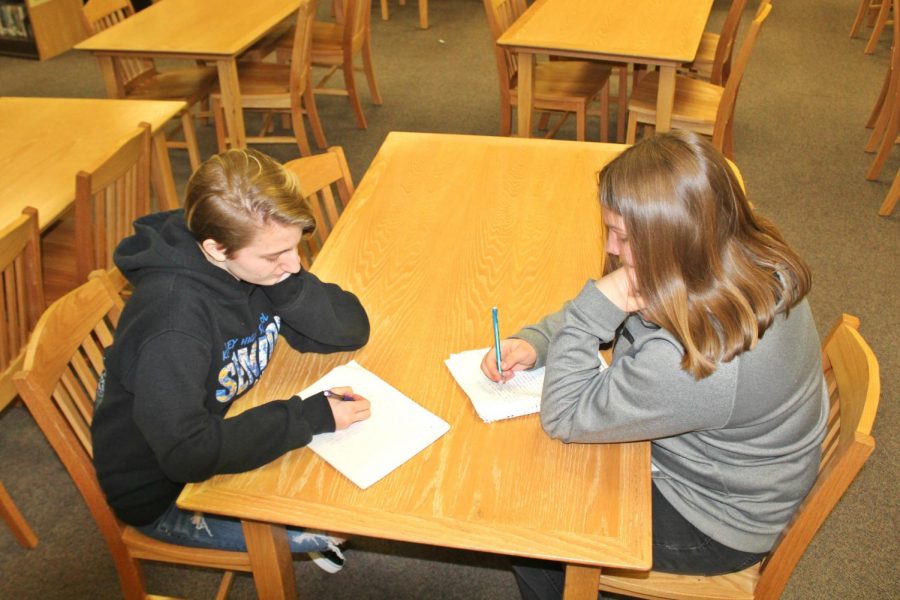 Senior Emily Rose (left) and freshman Haley Peters write letters to their past and future selves.