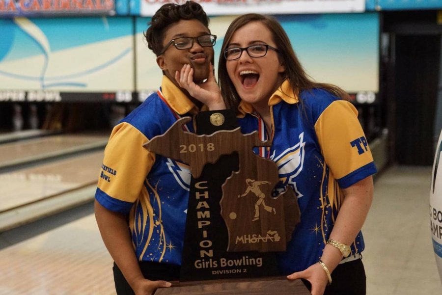 Sophomore Imari Blond (left) and senior Barbara Hawes pose happily with their team state title trophy. The girls both made the final four in the MHSAA Division 2 singles state final, Saturday, March 3. Blond advanced to the state title match, and finished second in the state.