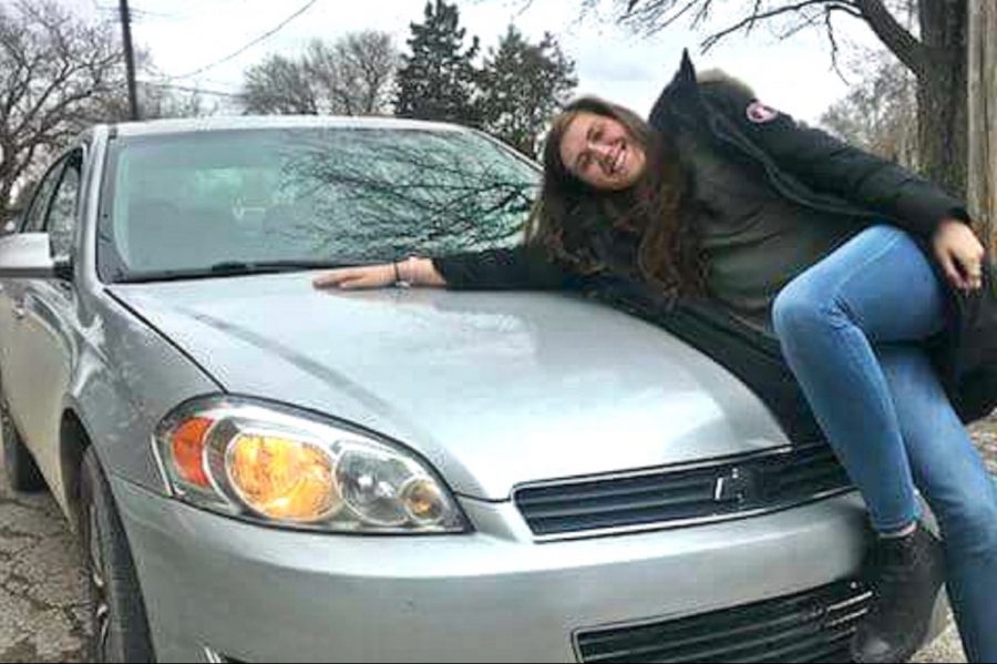 Senior+Samantha+Roberts+poses+happily+next+to+her+car.
