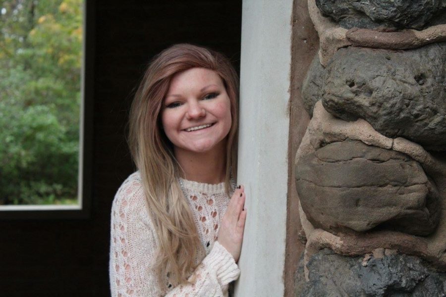 DeLong smiles against a rock wall for one of her senior photos.