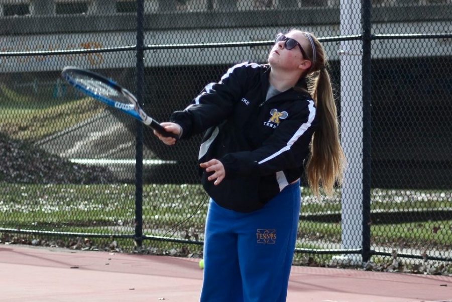 Sophomore Jillian Locke prepares to hit a ball at a tennis match earlier this year. 