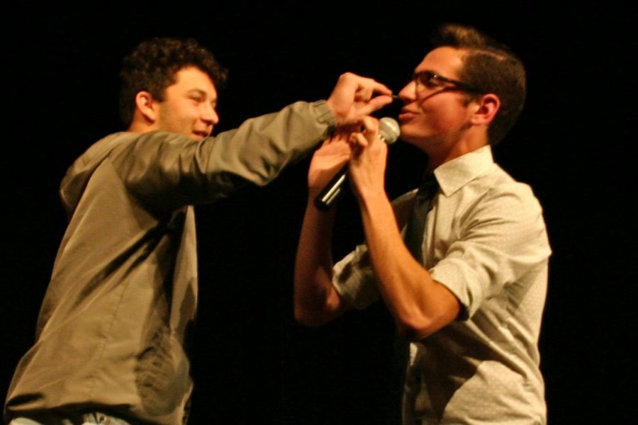 Junior Isaiah Constant pulls a nail out of senior Tyler Gronauer's nose. The nail was part of a trick Gronauer performed. His act also included magic and a bit of comedy.
