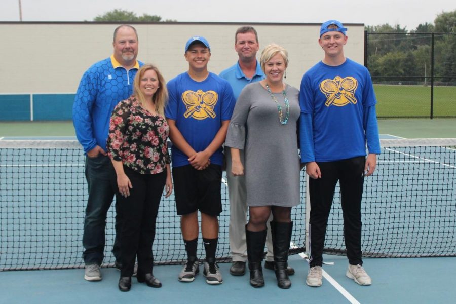 Seniors Kyle Langworthy (third from left) and Marshall Judd (far right) stand with their parents at their match against Flushing on Monday, Sept 24.