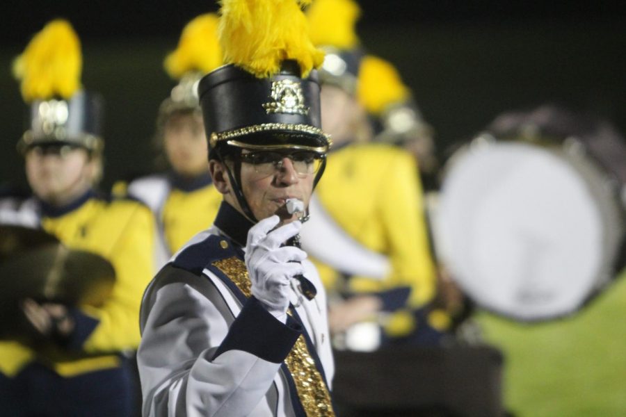 Senior Tyler Gronauer, drum major, leads the band during halftime of the homecoming football game on Friday, Oct. 5.