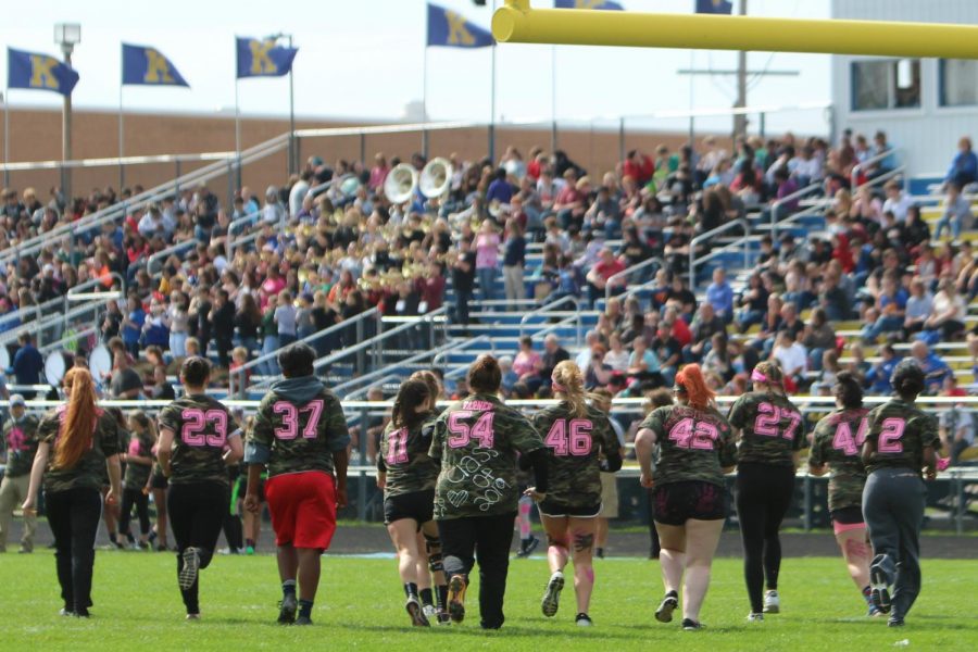 Seniors rush to the sidelines after defending their goal during the powder puff championship Wednesday, Oct. 3.