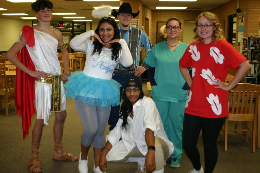 Several seniors in an English class show off their unique Halloween attire.