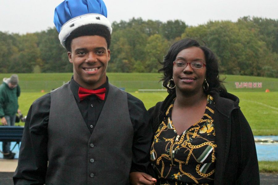 Senior Eddie Harris stands with his mother, Mrs. Diana Harris, after being crowned 2018 powder puff king on Monday, Oct. 1.
