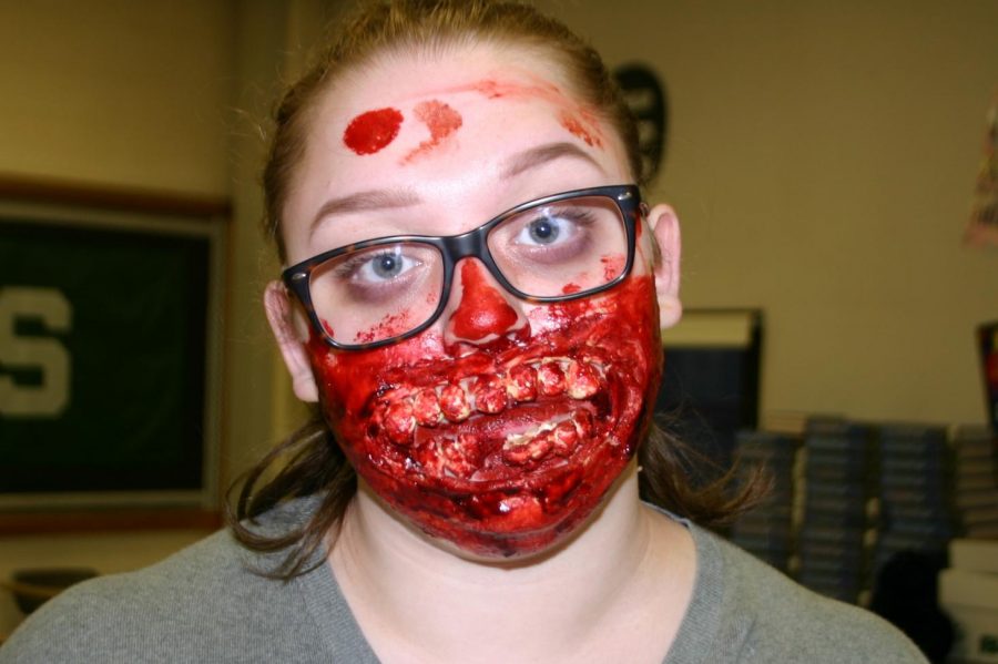 Senior Ashley Harroun creates a special effects makeup look for Halloween.