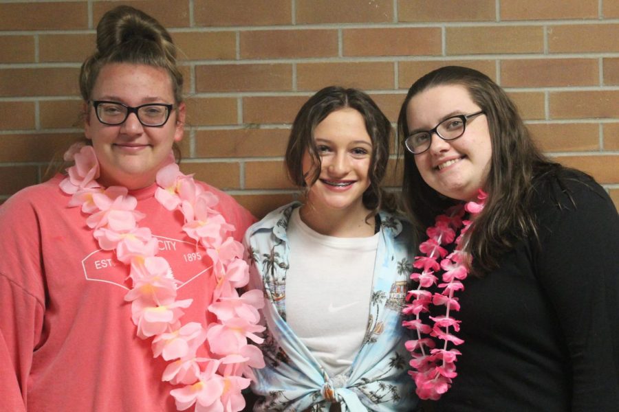 Freshmen Ivy Sanchez (l to r), Kelsey Caughlin, and Brooklyn Willhoite pose in leis and tropical colors to show off their school spirit.