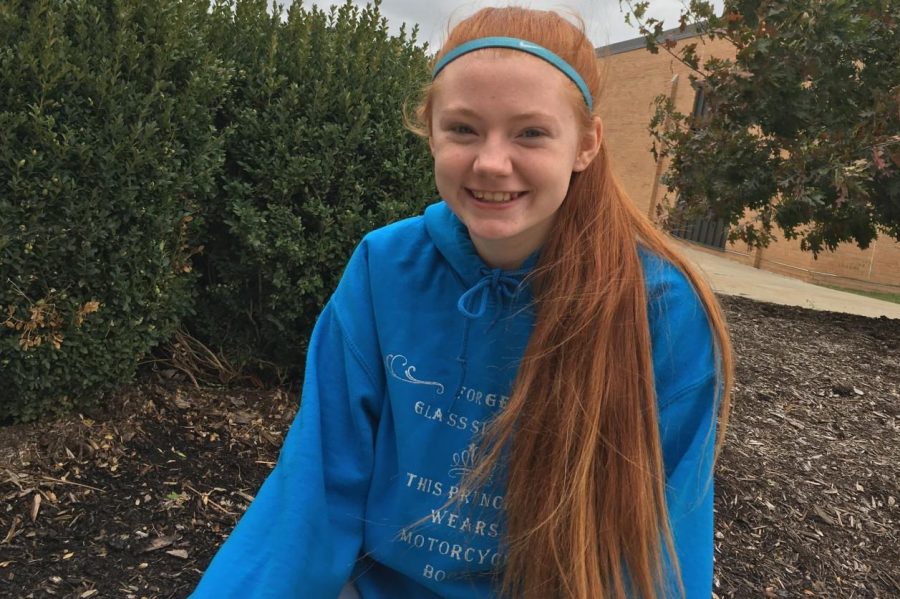 Senior Amber Hardy embraces her signature look as a redhead.