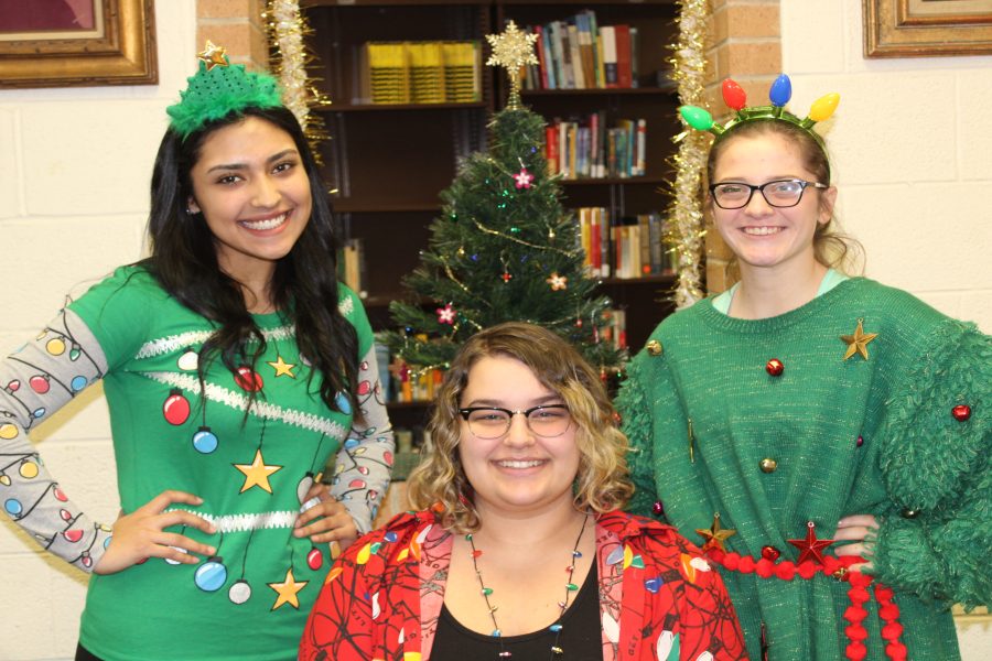 Senior Mariana Arambula (l to r) and juniors Delanie Schreiber and Alyssa Smith express their Christmas spirit by participating in the holiday spirit week day dress up like a Christmas tree.