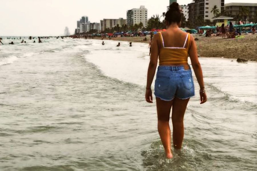Foreign exchange senior Giulia Amato walks the beach in Miami, Fla.
