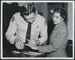 Mrs. Rosa Parks being fingerprinted by Sheriff D.H. Lackey for refusal to give up her seat to a white passenger and refusal to move to the back of the bus. This event marked the start of the Montgomery Bus Boycott.