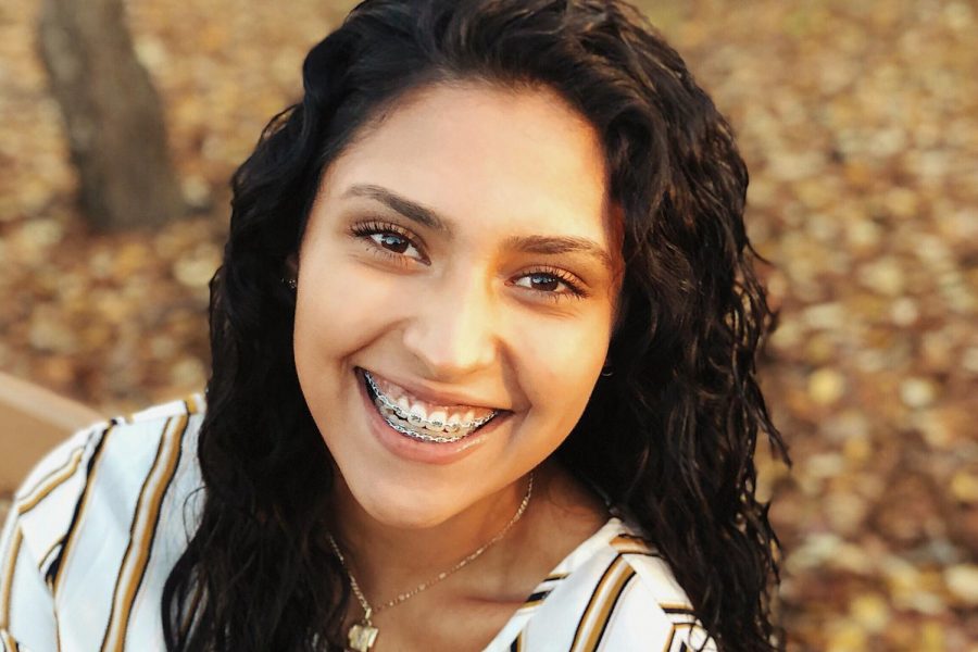 Senior Mariana Arambula smiles during a photo shoot for her senior pictures at For-Mar Nature Preserve.