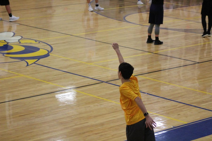 Freshman Sam Kelsey serves a ball.
