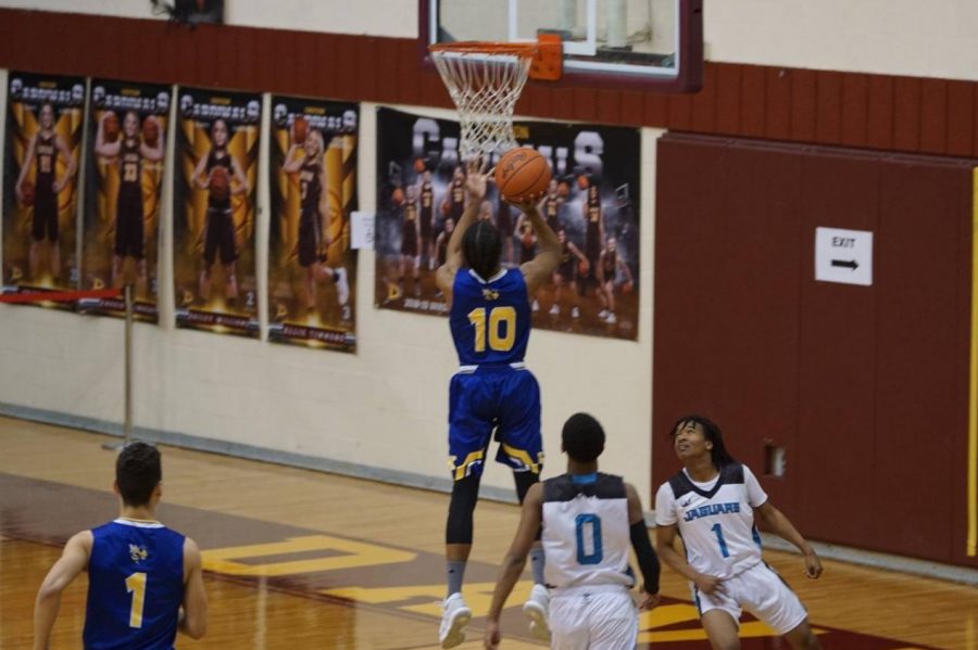 Senior Saif Dawan led the Hornets to victory by scoring 19 points against the Flint Jaguars on Monday, Feb. 25. 
