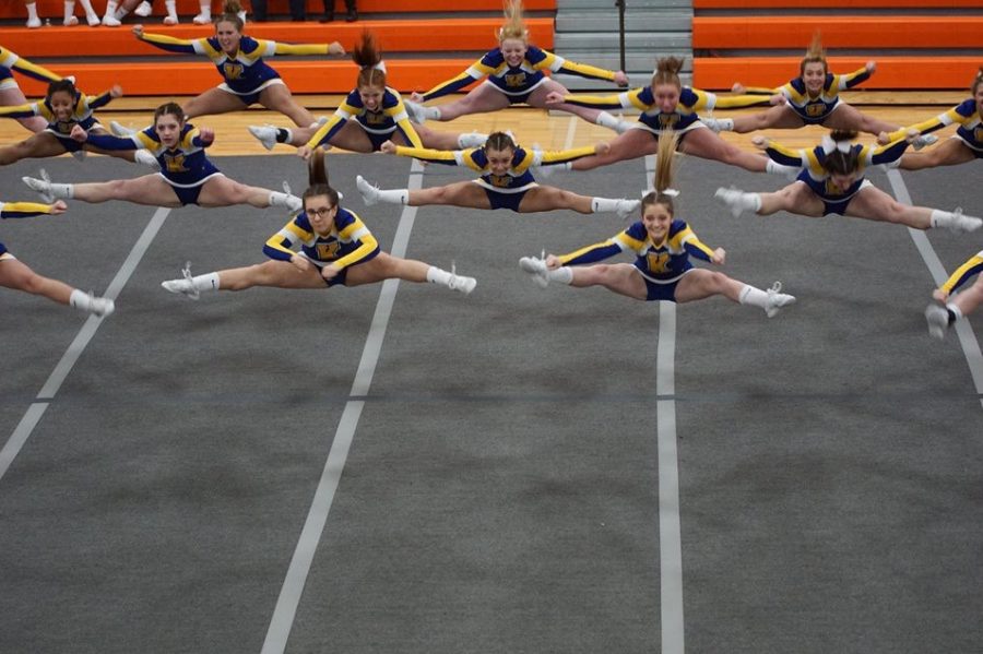 The+cheer+team+jumps+into+the+splits+during+the++third+Metro+League+competition.+The+Hornets+took+second+in+their+competition+on+Thursday%2C+Feb.+14.