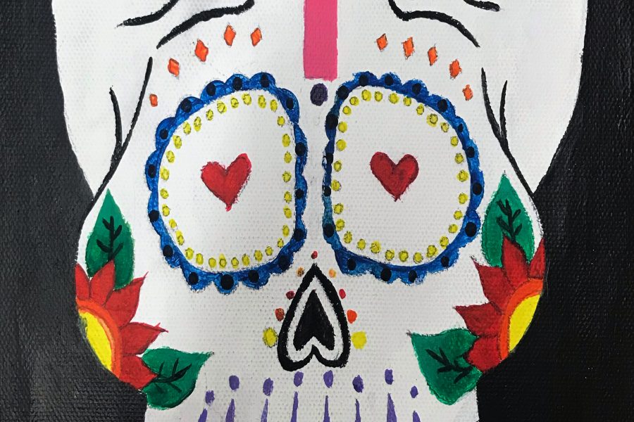 Macie Godfrey, senior, painted a sugar skull to celebrate Dia de los Muertos.