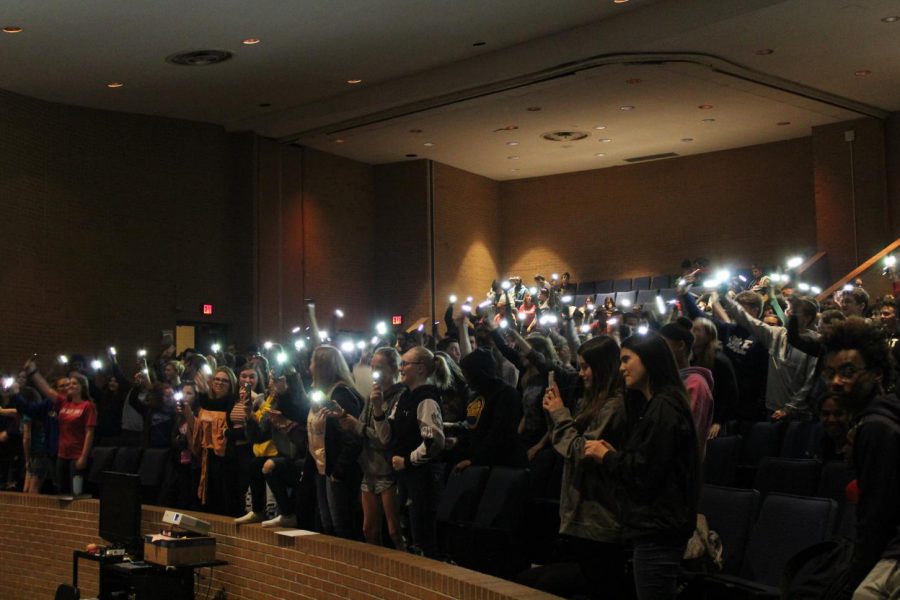 Sophomores and seniors wave their phone flashlights in the air to The Reminders music. The singing duo performed Friday, April 26.