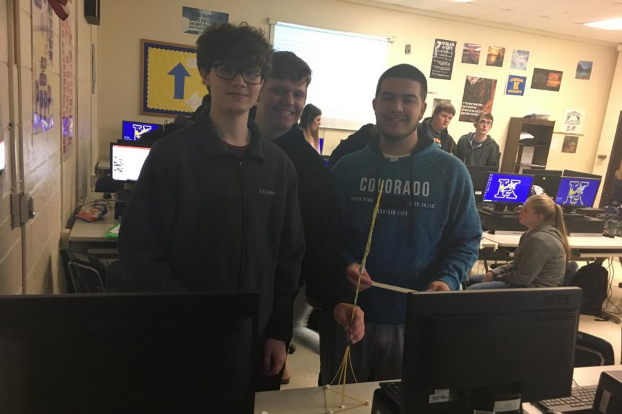Seniors Austin Bailey, Dustin Bennett, and Spencer Tarrants work together to make their tower the tallest in Mr. Nick VanDusers finance class on Monday, April 22.