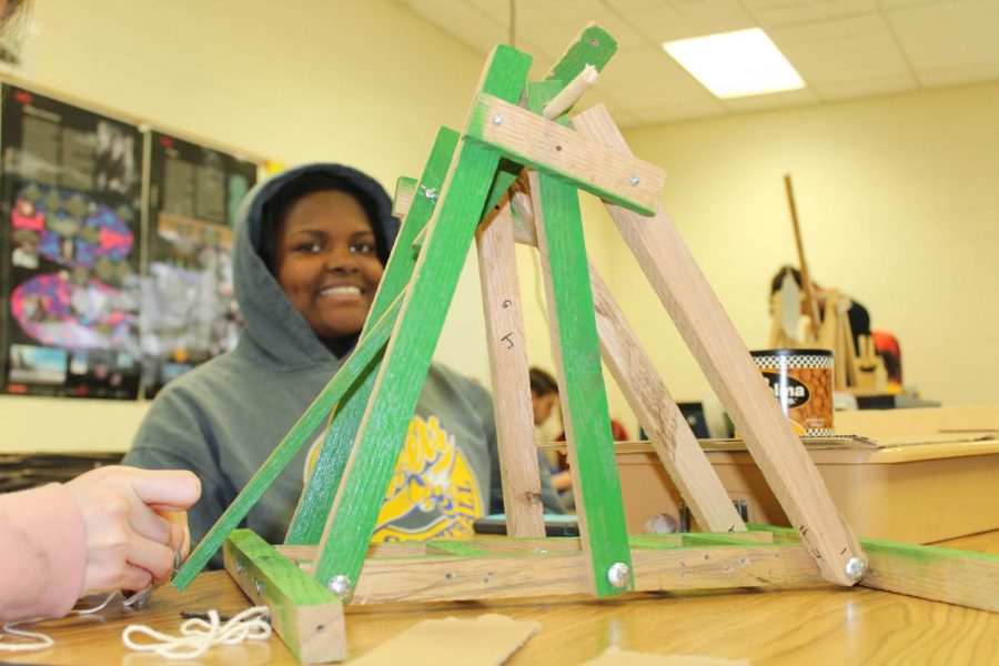 Senior Chiny Miles and her group make a trebuchet for STEM education in physics.
