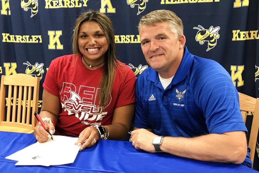 Senior Mackenzie Ramey (left) sits with Coach Mike 
 Simms as she signs her National Letter of Intent to compete with Saginaw Valley State Universitys track and field team. Ramey signed on Thursday, May 16.