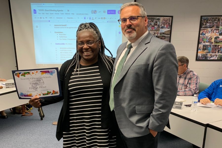 Mrs. Lachelle Pool (left) receives the September Hornet Hero award from Mr. Kevin Walworth, superintendent, during a Board of Education meeting at the administration building Monday, Sept. 9.