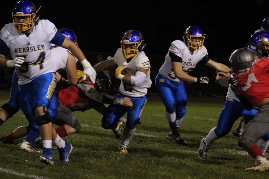 Junior Isaiah Stiverson cuts between his blockers in a football game at Holly on Friday, Oct. 4. Stiverson scored three touchdowns in the game.
