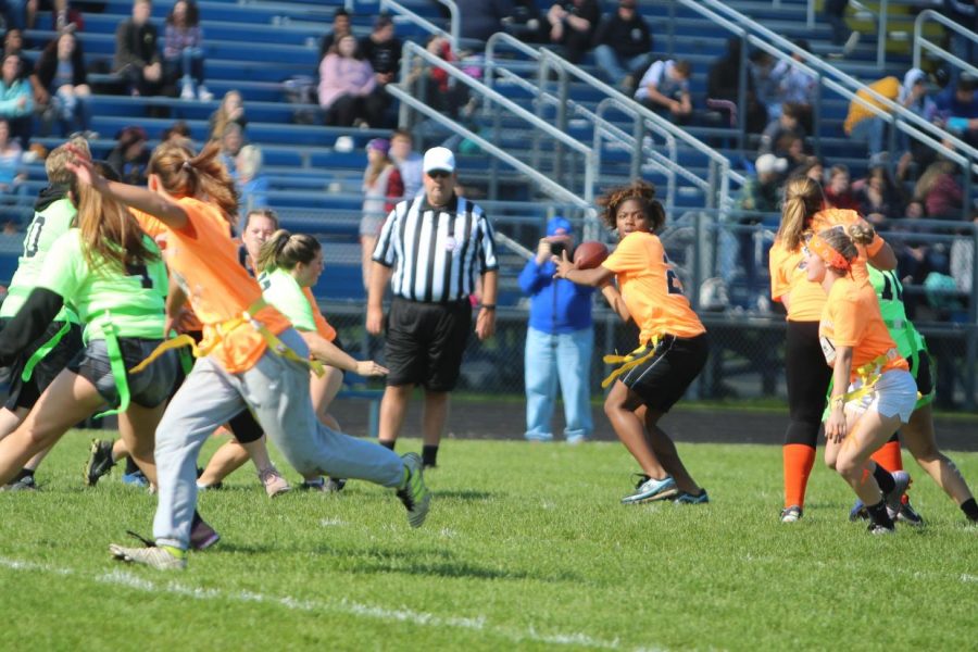 Senior JaKeira Wash (center) looks downfield at senior receiver Alexis Echols (second from left) who motions for the pass in the powder puff championship game Wednesday, Oct. 9, at KHS.