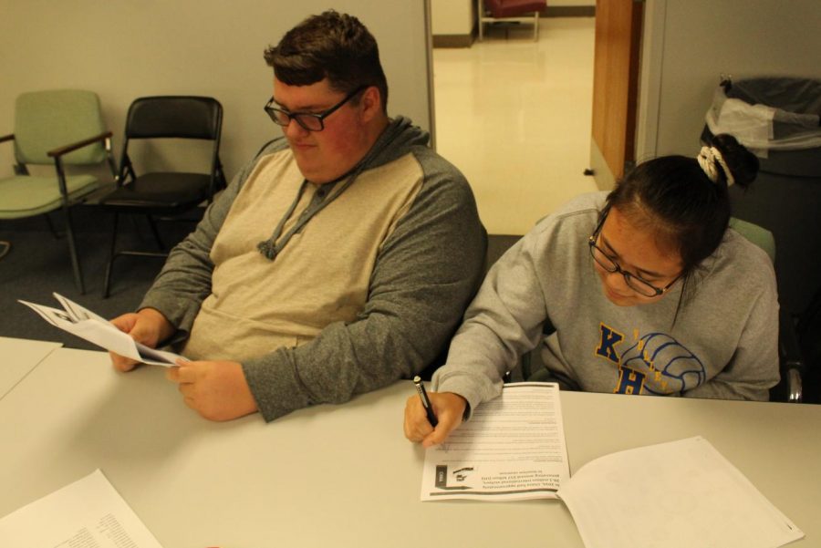 Sophomores Gage Slagor (left) and Aizya Sorensen research international travel in Future Problem Solving practice Friday, Oct. 18, at the administration building.
