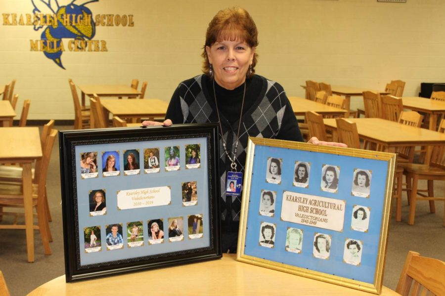 Mrs. Sally Brandt compares a new valedictorian frame (left) with an old valedictorian picture frame (right). The frames will remain in front of the main office.
