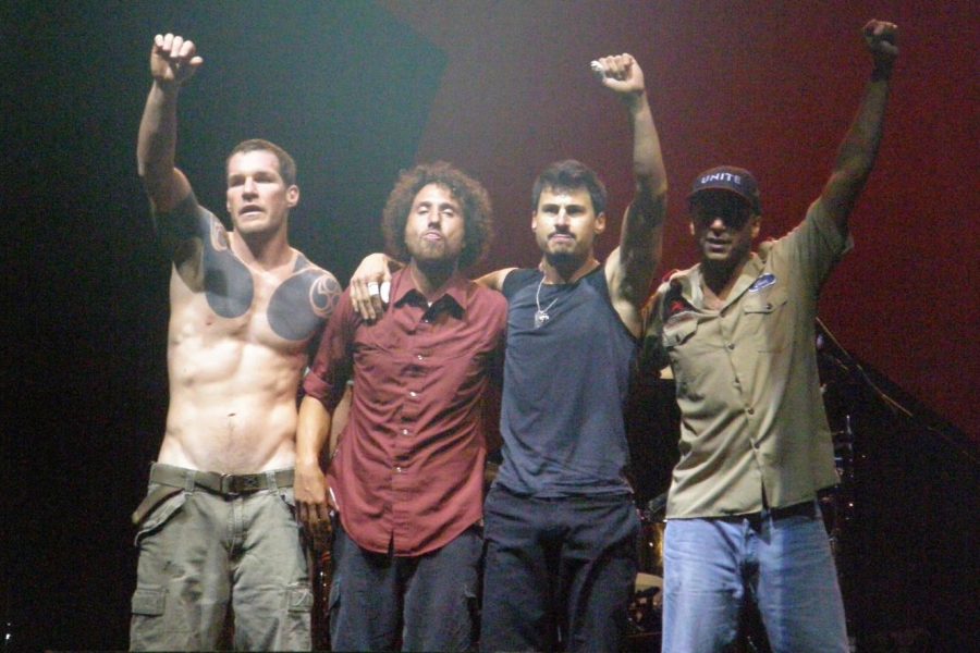 Rage Against the Machine holds up power fists at the end of a reunion performance in 2007.