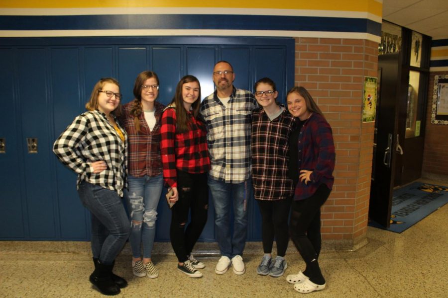 (From Left) Juniors Katie Davidson, Allyson Link, Alayna Roster, Mr. Chris Torok, Megan Timm, and senior Shelby Cranmer pose with various types of flannels on Flannel Day.