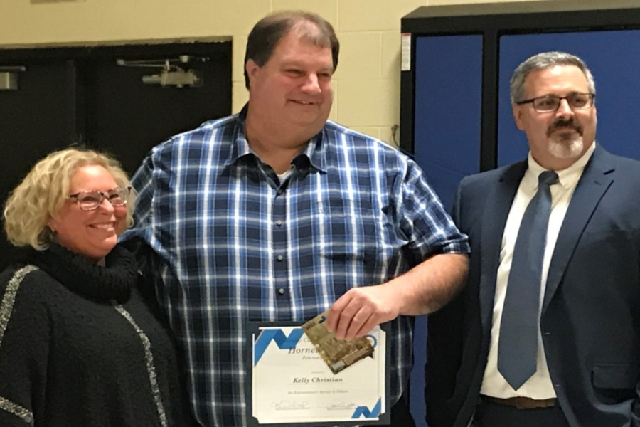 Mr. Kelly Christian (center) accepts the Hornet of the Month award from Board of Education President DesRae Joubran and Superintendent Kevin Walworth Tuesday, Feb. 11.