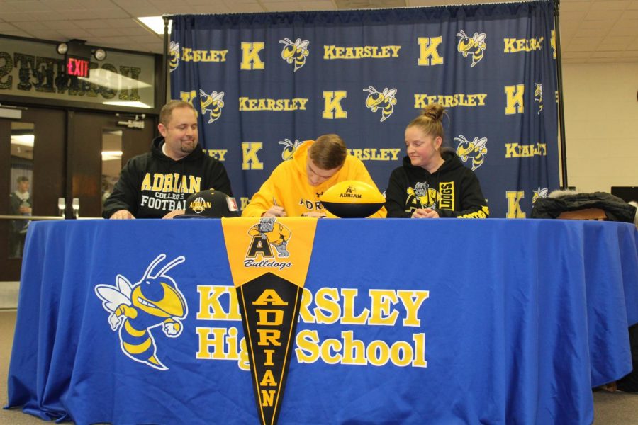 Senior Ethan Livingston (center) signed his National Letter of Intent to play football at Adrian College Friday, Jan. 31.