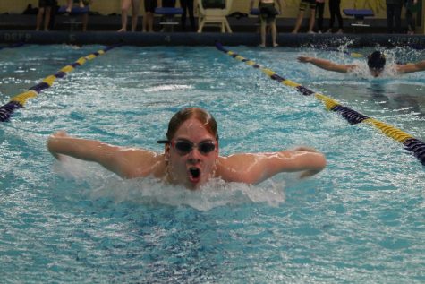 Sophomore Brodie Dustin swims the 50-meter butterfly against Owosso in the 200 medley relay. 