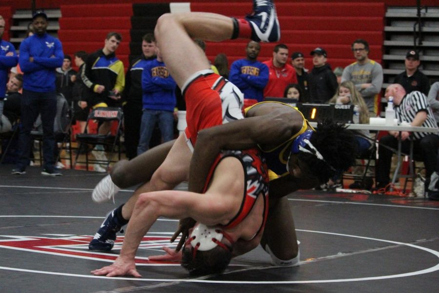 Senior John Brown (back) throws his Swartz Creek opponent to the mat during the Metro League championship match at Linden Saturday, Feb. 8.