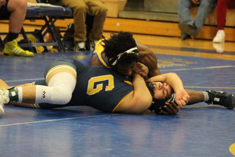 Senior LaRon Ruffin attempts to pin his Goodrich opponent during an MHSAA Division 3 team district tournament Wednesday, Feb. 12.
