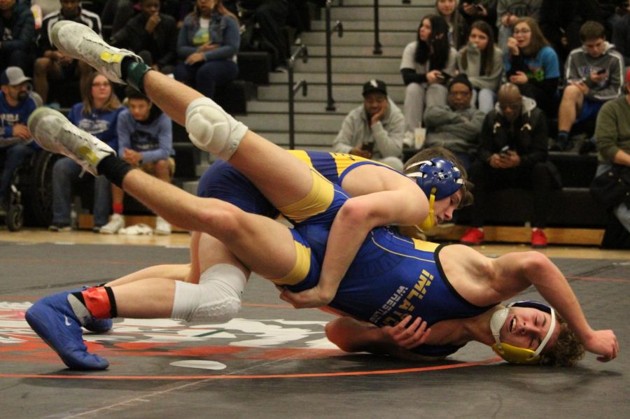 Sophomore Kaleb Gettings attempts to turn his Imlay City opponent during the MHSAA Division 3 individual district tournament at Fenton Saturday, Feb. 15.