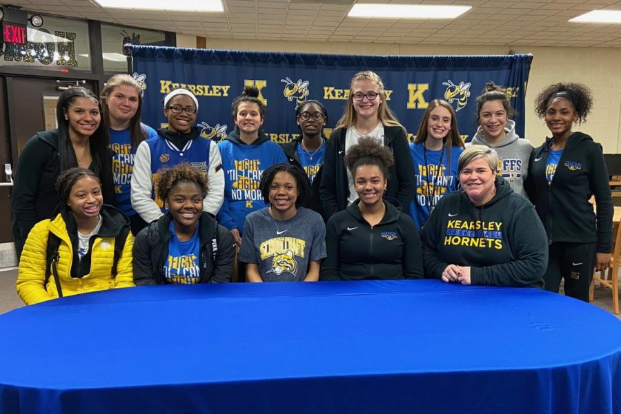 Senior+MarKayla+Shannon+%28front+row%2C+center%29+signed+her+National+Letter+of+Intent+to+play+basketball+at+Schoolcraft+College+Monday%2C+March+3.+Her+coaches+and+friends+supported+her+at+the+signing.