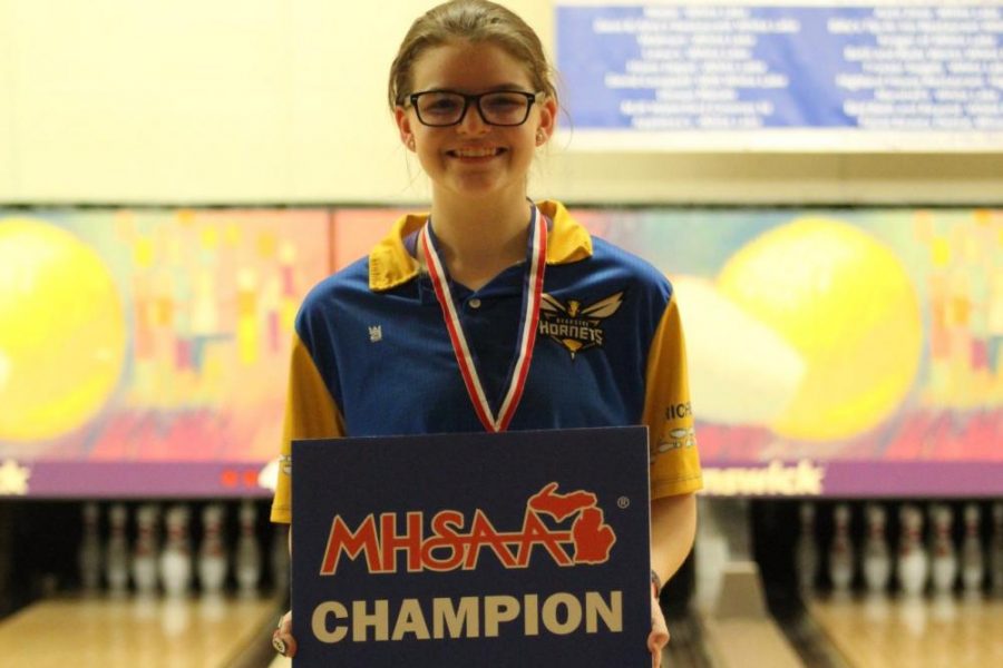 Junior Megan Timm poses after winning the MHSAA Division 2 individual state final.