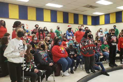 The choir classes, including concert choir, a capella, and the middle school choir, practice for their Christmas choir concert.