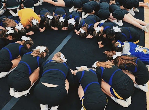 The competitive cheer team sits and waits for their results for the first time in the season.