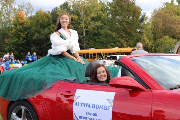 Queen Candidate Alyvia Bombe riding in the Homecoming Parade.