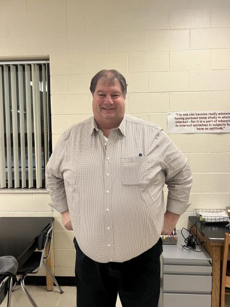 Mr. Christian smiles in his classroom at Kearsley High School. 